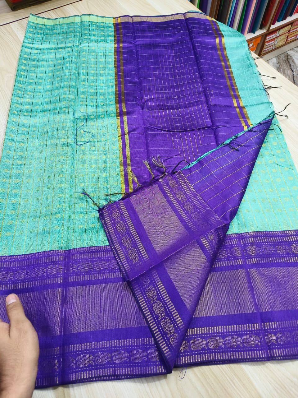 Sky blue semi raw silk saree with purple border and pallu